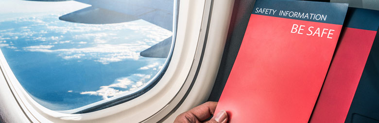 A passenger on a flight reading about the different steps their airline is taking to help keep them safe.