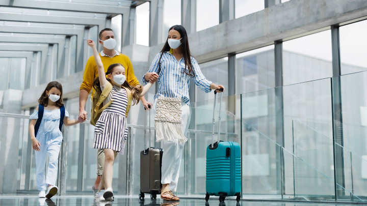 A family walking through an airport.